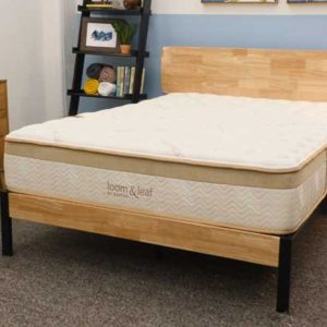 the saatva loom and leaf mattress in a bedroom with no bedding