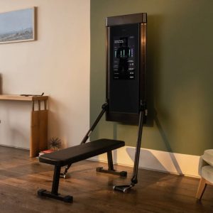 Tonal's home gym functional trainer mounted on a wall in a home, with a weight bench