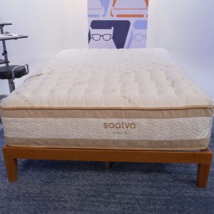 the luxury mattress saatva classic rx without bedding on a wooden bed frame