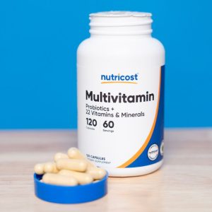 bottle of nutricost multivitamins sitting on counter with capsules