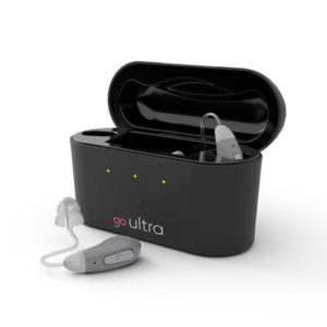 Black GoHearing Go Ultra case with one hearing aids inside and one in front of the case