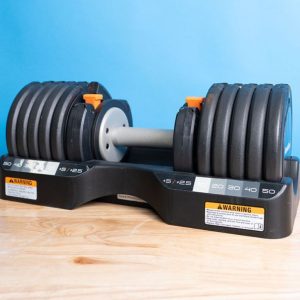 the nordictrack select a weight dumbbell set on a counter top in front of blue wall