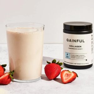 gainful grass fed collagen next to the glass of prepared powder with the strawberries arround