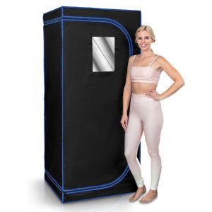 a woman is standing next to the serenelife portable full size infrared home spa sauna