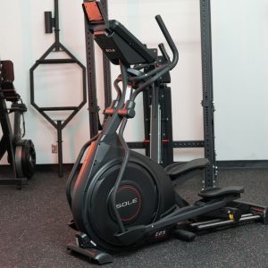 A Sole Fitness E25 elliptical machine sits in a gym.