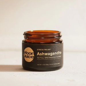 A brown glass jar of ashwagandha root extract powder with a black label, placed against a white background.