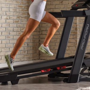 a woman running on the proform carbon tlx treadmill