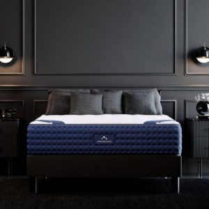 A mattress with a dark blue base and white top surface, featuring blue corner handles