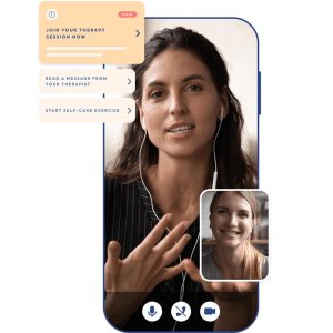 A smartphone screen displaying a video call with a female therapist. The user interface includes options for joining a therapy session, reading a message from the therapist, and starting a self-care exercise. The main video shows a woman with long dark hair speaking, while a smaller inset video shows another woman smiling.