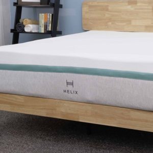 Helix Sunset mattress displayed on a wooden bed frame, highlighting its soft and supportive structure.